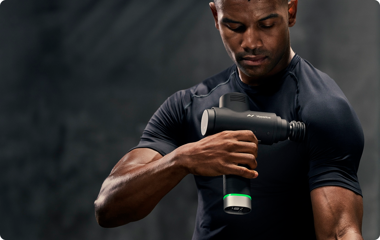man with a Hyperice machine massaging his arm
